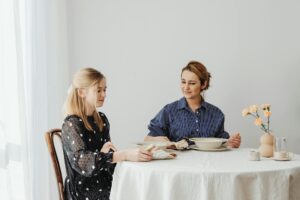 Mother and teenage daughter sharing a meal at the family dining table, the usual setting for the multidisciplinary treatment of eating disorders